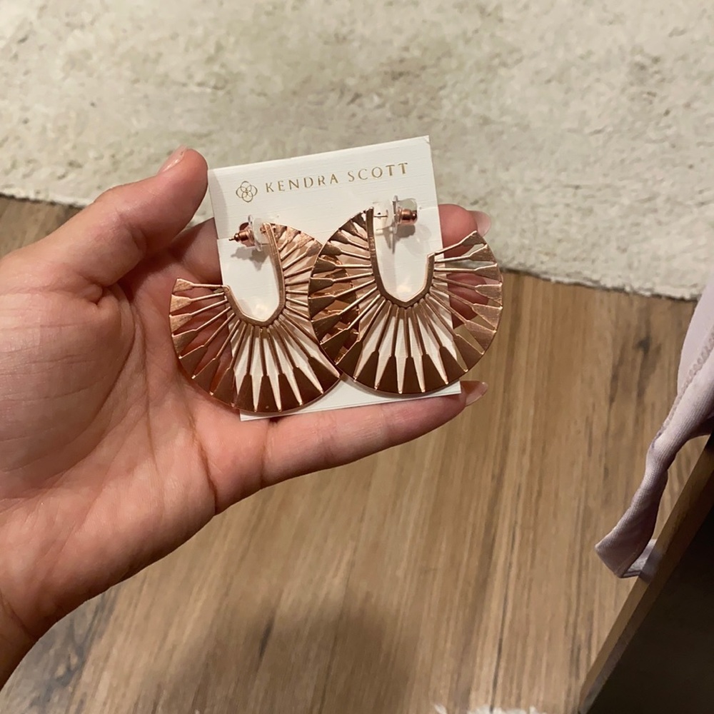 Chunky rose gold Kendra Scott earrings.